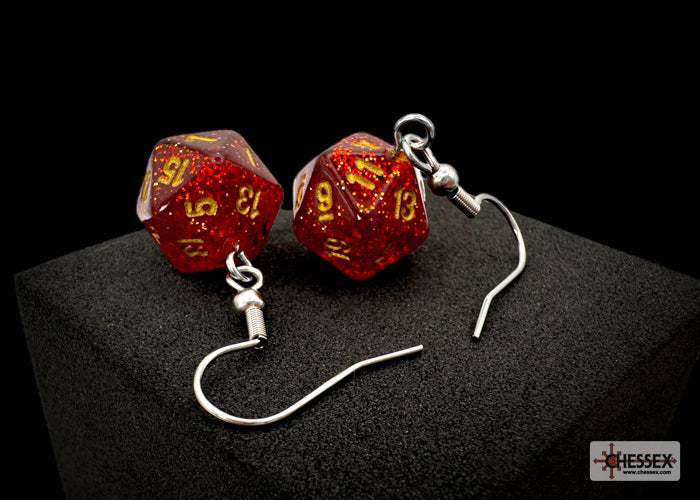 Pair of red and gold dice-shaped earrings on a black background
