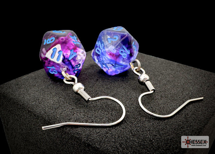 Pair of dice-shaped earrings on a black background with 'Chessex' branding.