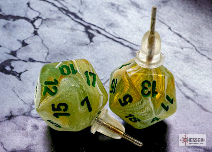 Two green polyhedral dice with black numbers on a marble surface, featuring the Chessex brand.