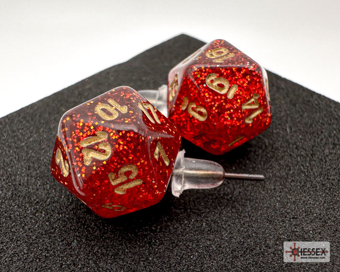 Red glittery polyhedral dice with gold numbering on a black surface, branded 'Essex'.