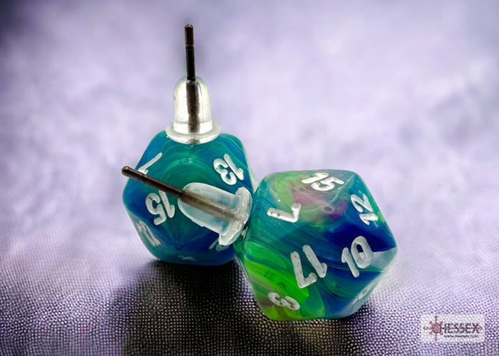 Two polyhedral dice with blue and green marbled pattern on a textured surface