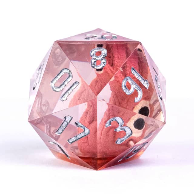 Polyhedral dice with rose gold and clear transparent finish on a white background