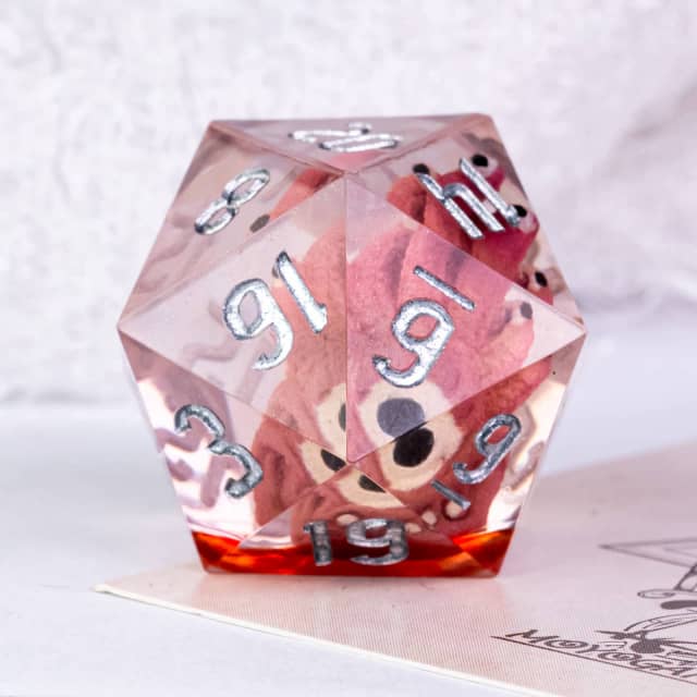 Translucent pink polyhedral dice with silver numbers on a white background