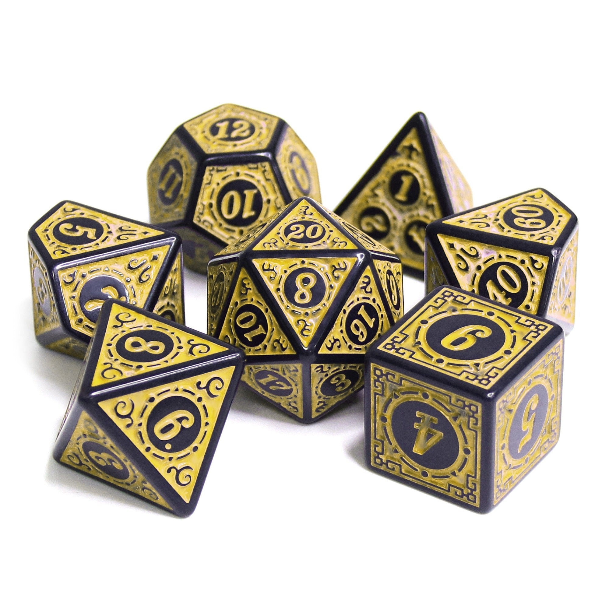 Set of gold and black polyhedral dice on a white background