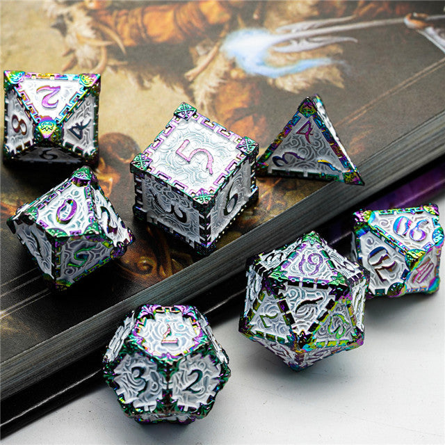 Set of metallic polyhedral dice with intricate designs on a textured surface.