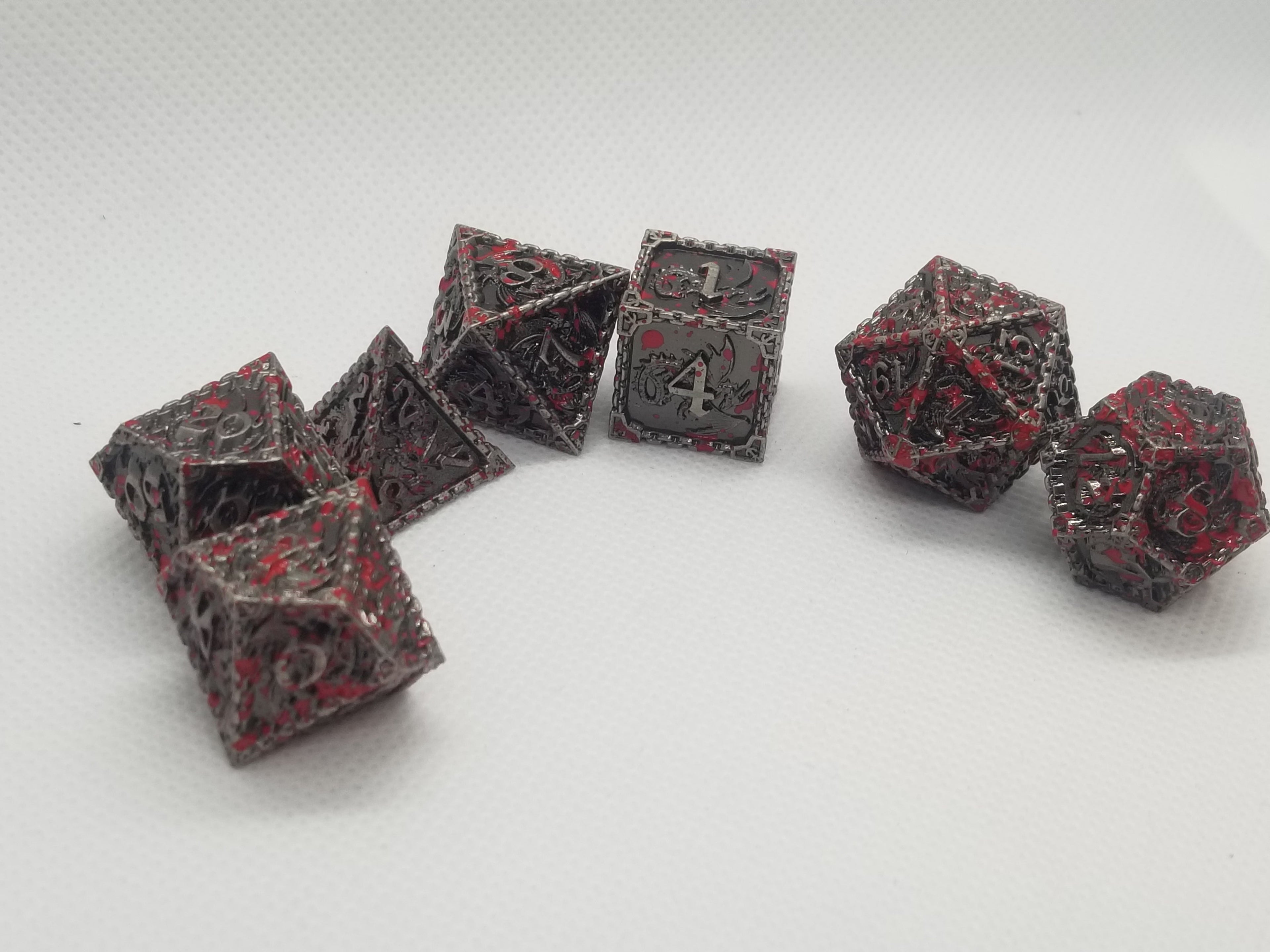 Set of polyhedral dice with red and black patterns on a white background