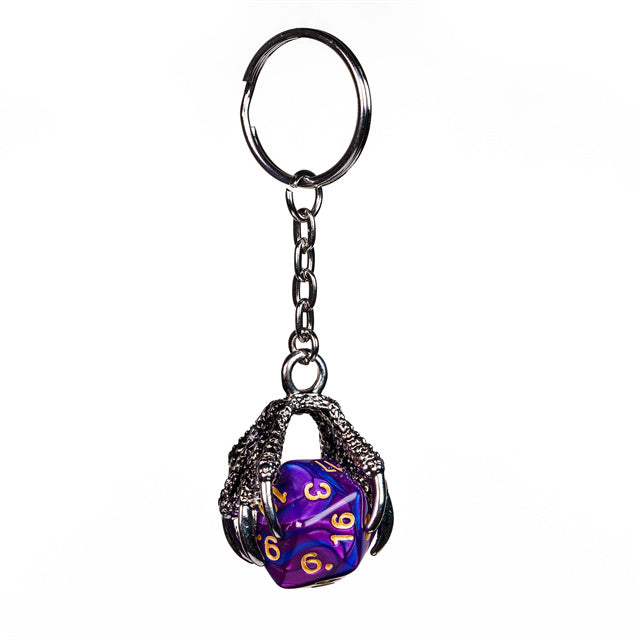 Keychain with a purple and blue die inside a metal cage on a white background
