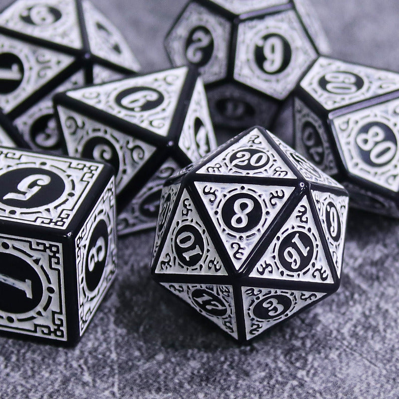 Black and white polyhedral dice on a textured surface