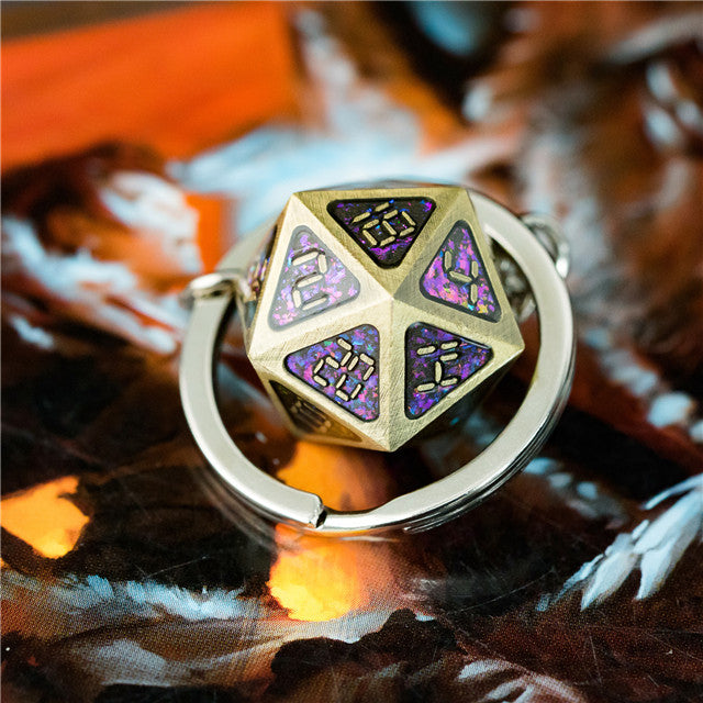 Gold and purple dice-shaped ring on a reflective surface