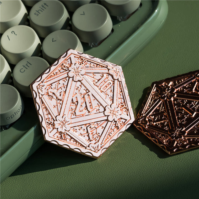 Decorative metal pins on a green surface with keyboard keys in the background