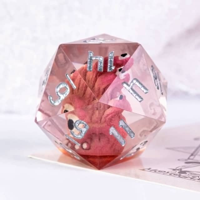 Translucent pink polyhedral die with silver numbers on a white background