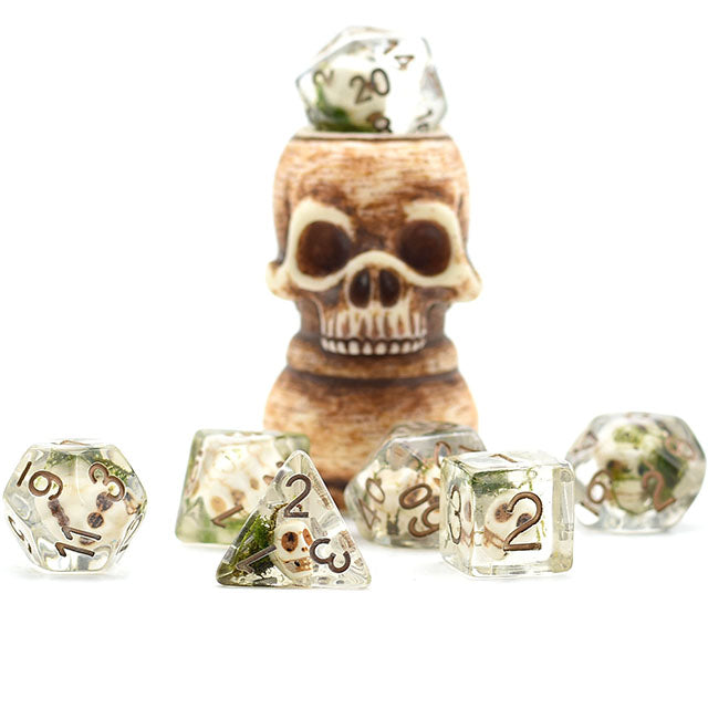 Set of dice with a skull-shaped dice holder on a white background