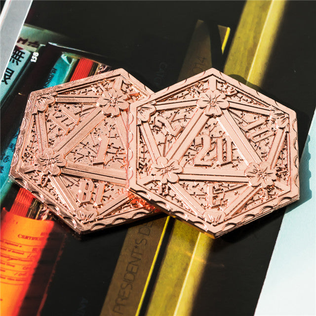 Two ornate bronze or copper objects with intricate designs on a black background.