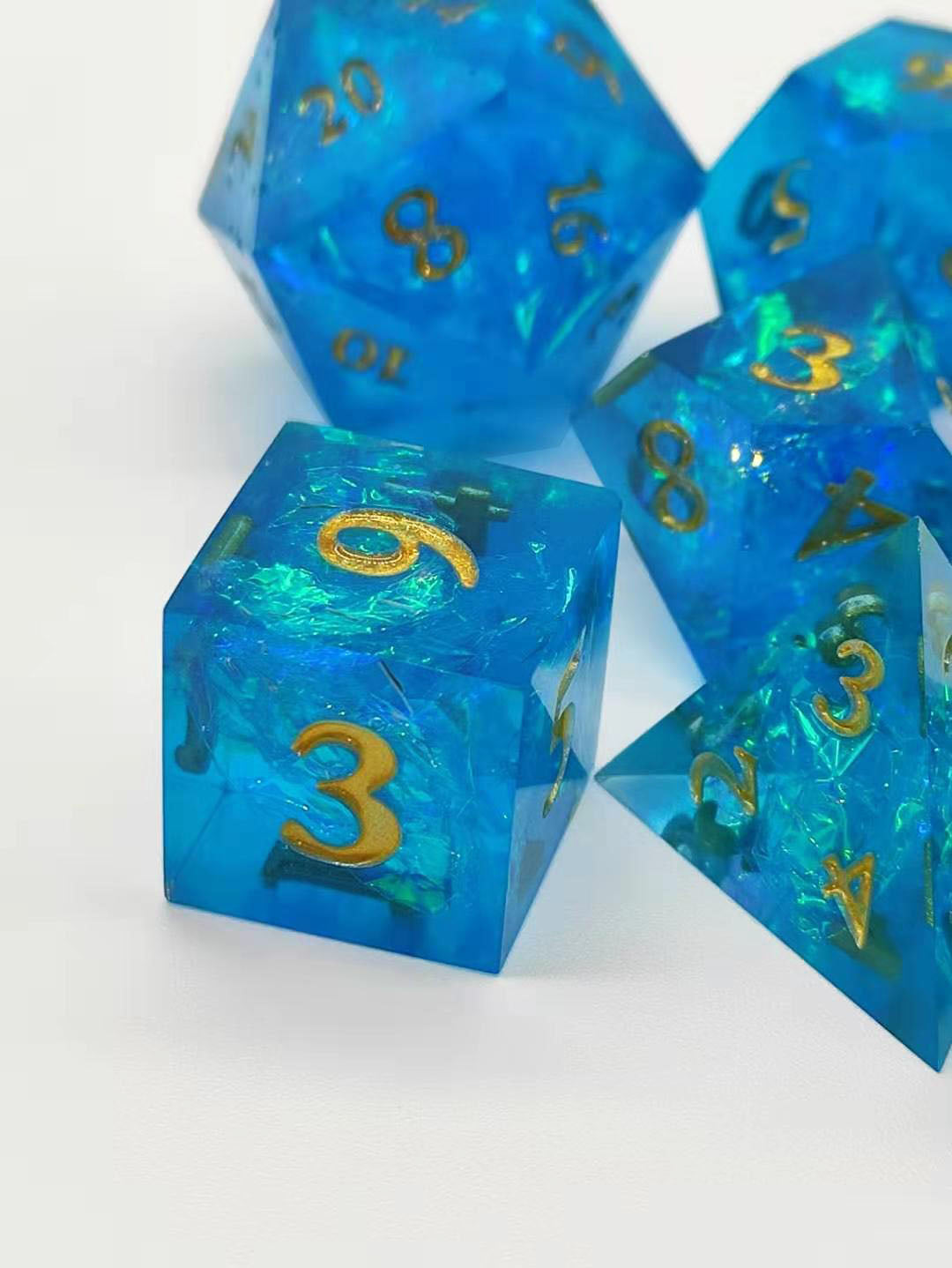 Set of blue dice with gold numbers on a white background