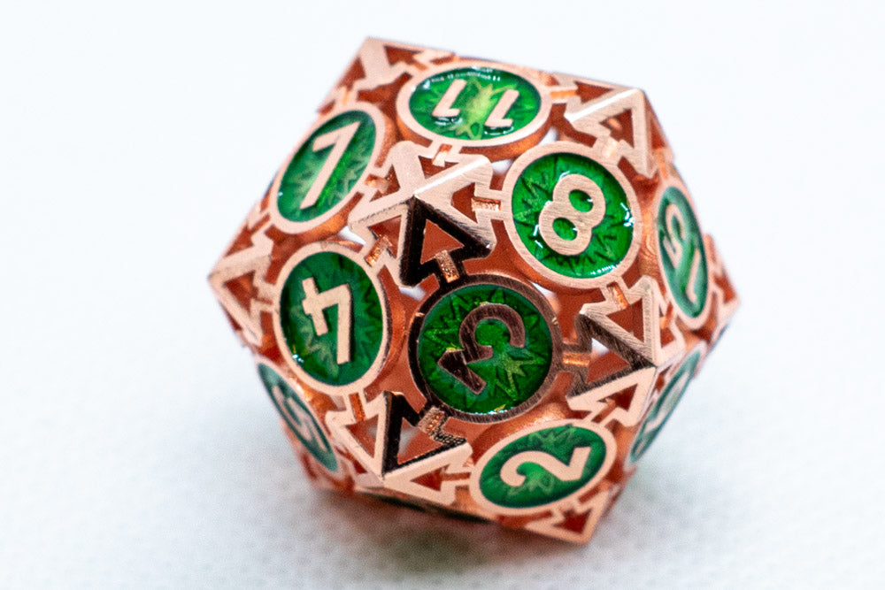 Polyhedral dice with copper and green design on a white background