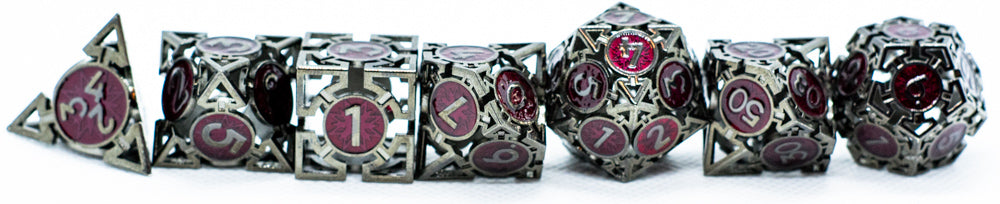 Set of metal dice with intricate designs and numbers on a white background