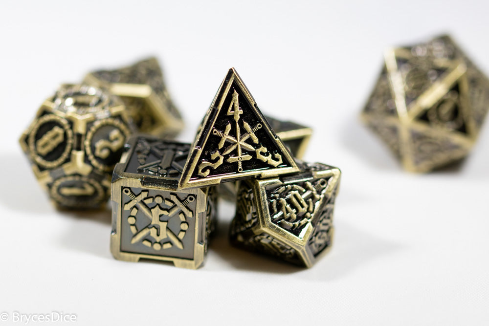 Set of metallic polyhedral dice with intricate designs on a white background