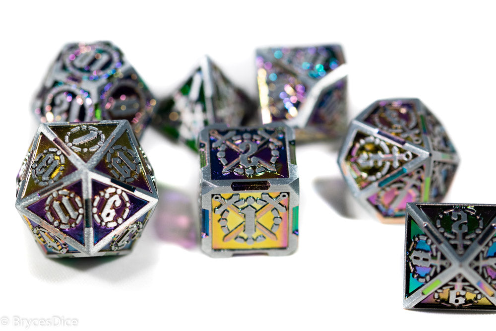 Metal dice set with intricate designs on a white background