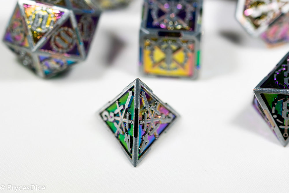 Close-up of metallic polyhedral dice with colorful patterns on a white surface.