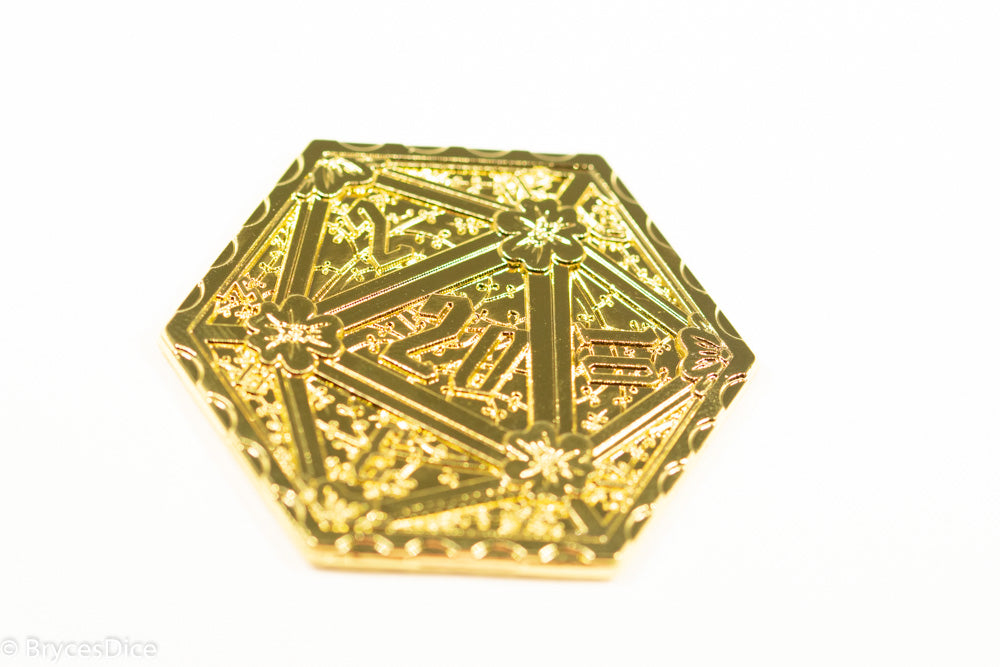 Gold metallic d20 dice on a white background