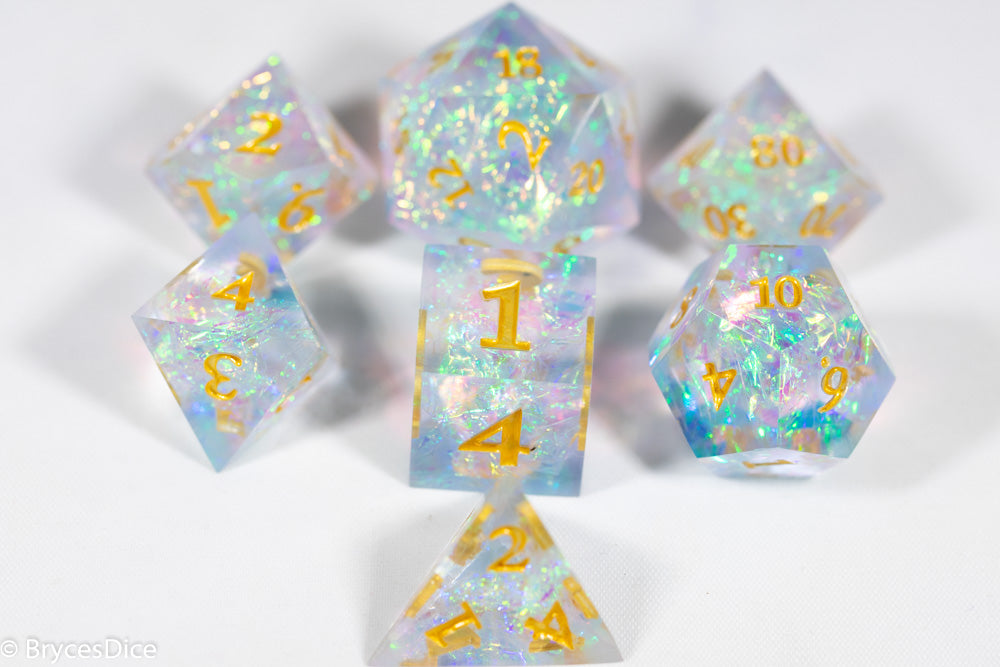 Set of holographic polyhedral dice with gold numbers on a white background