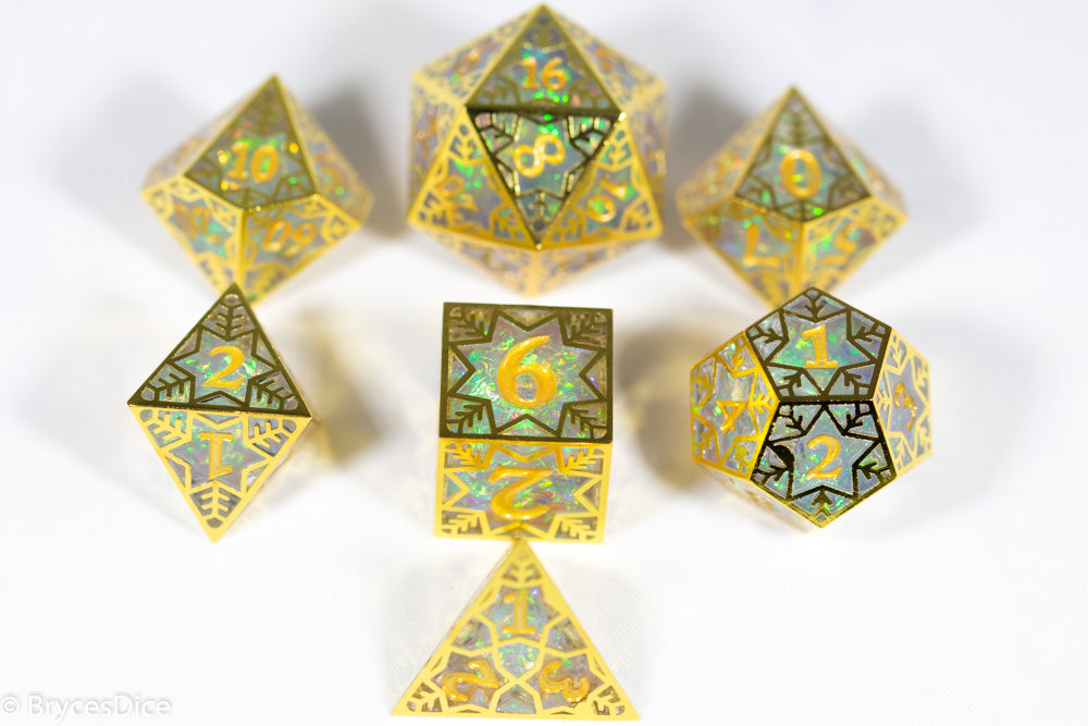 Set of metallic polyhedral dice with green and gold patterns on a white background