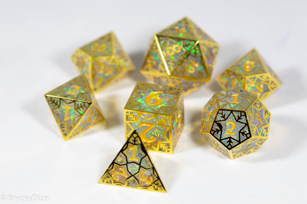 Set of gold and silver polyhedral dice on a white background