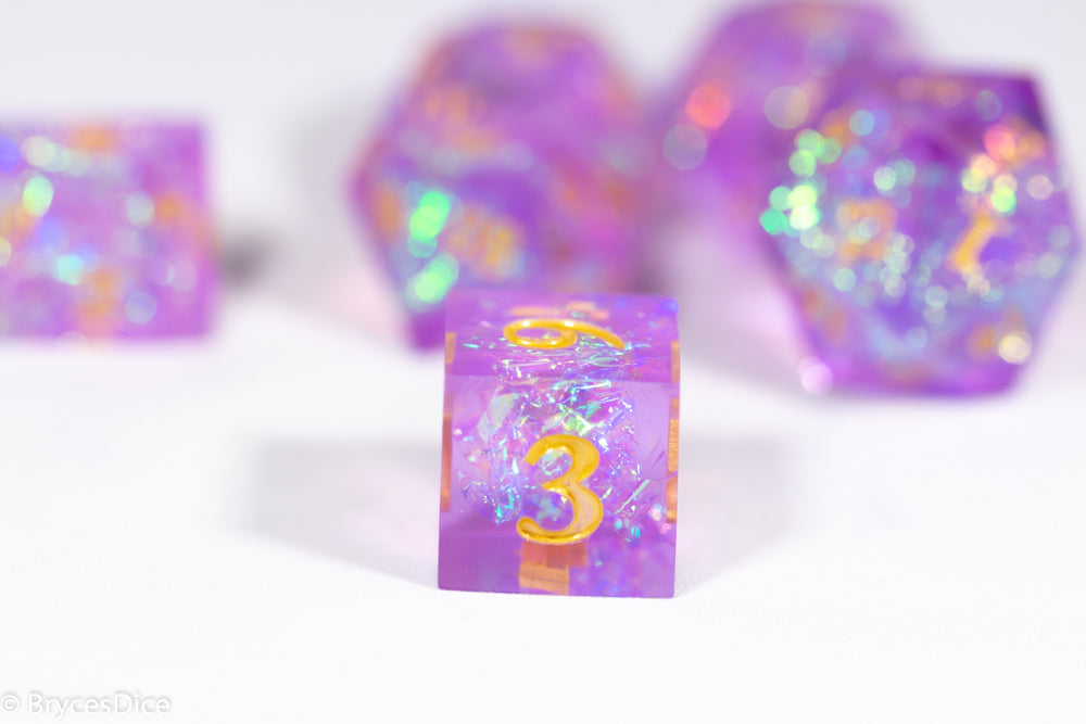 Purple dice with colorful glittery finish on a white background