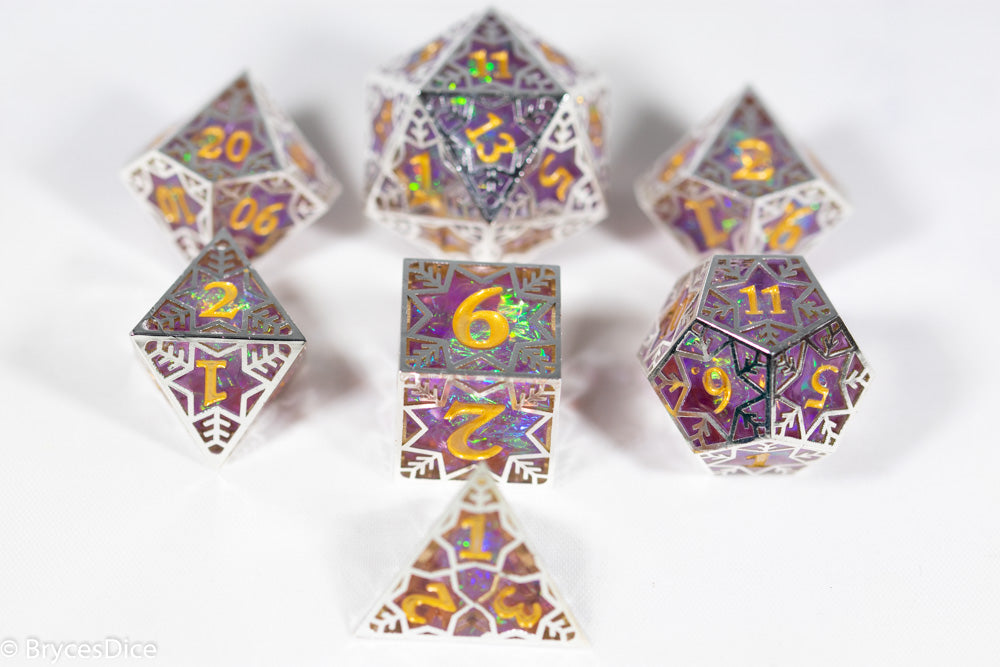 Set of polyhedral dice with purple and gold design on a white background