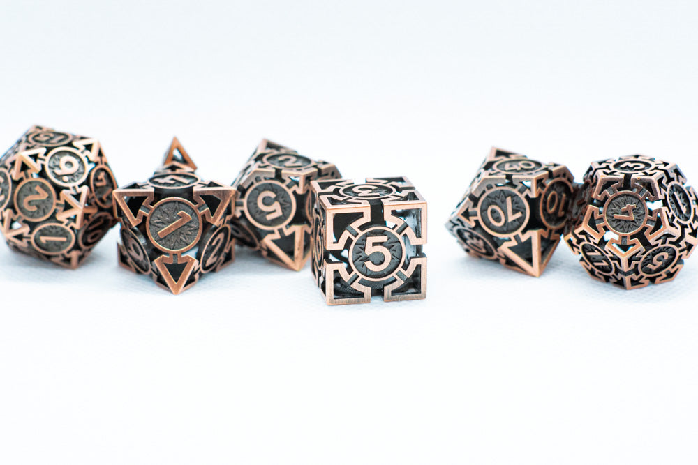 Set of bronze polyhedral dice on a white background