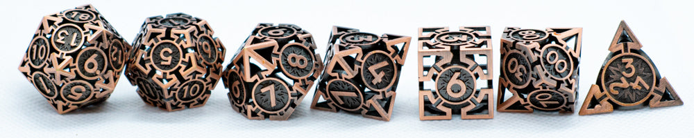 Set of bronze polyhedral dice with intricate designs on a white background
