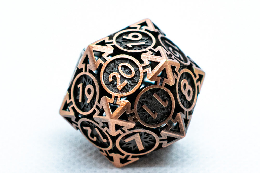 Metallic polyhedral dice with black and copper numbers on a white background