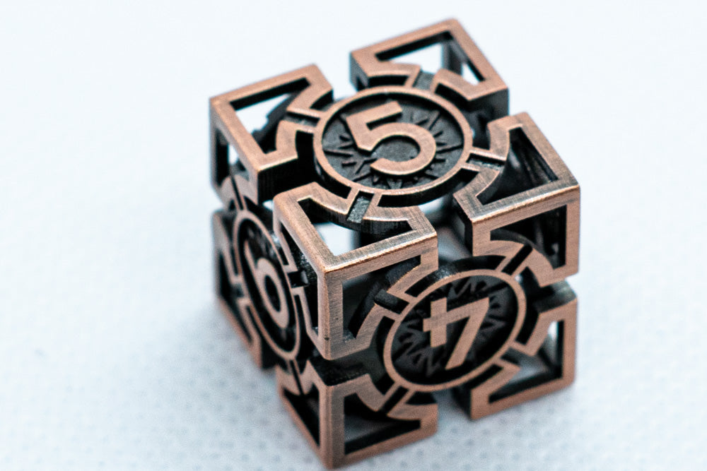 Bronze cube with numbers and symbols on a white background