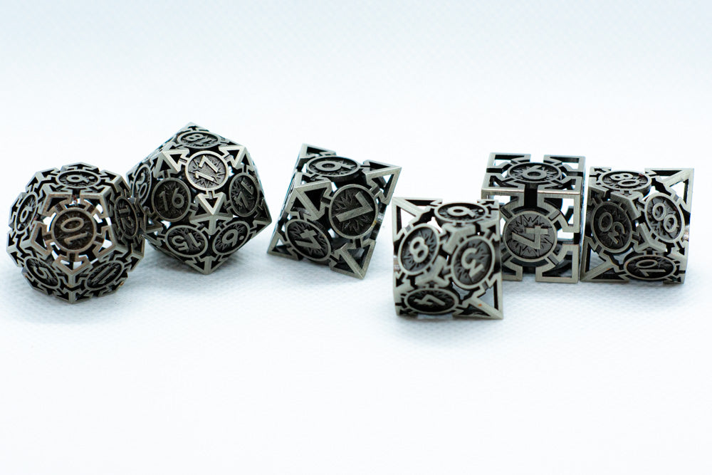 Set of metallic polyhedral dice on a white background