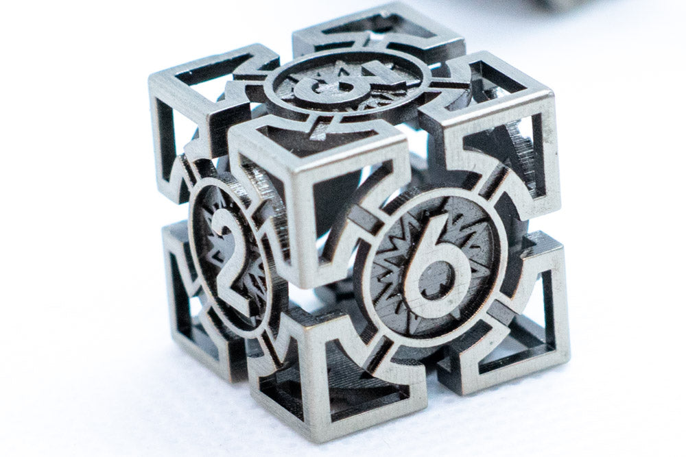 Metallic puzzle cube with numbers and geometric shapes on a white background