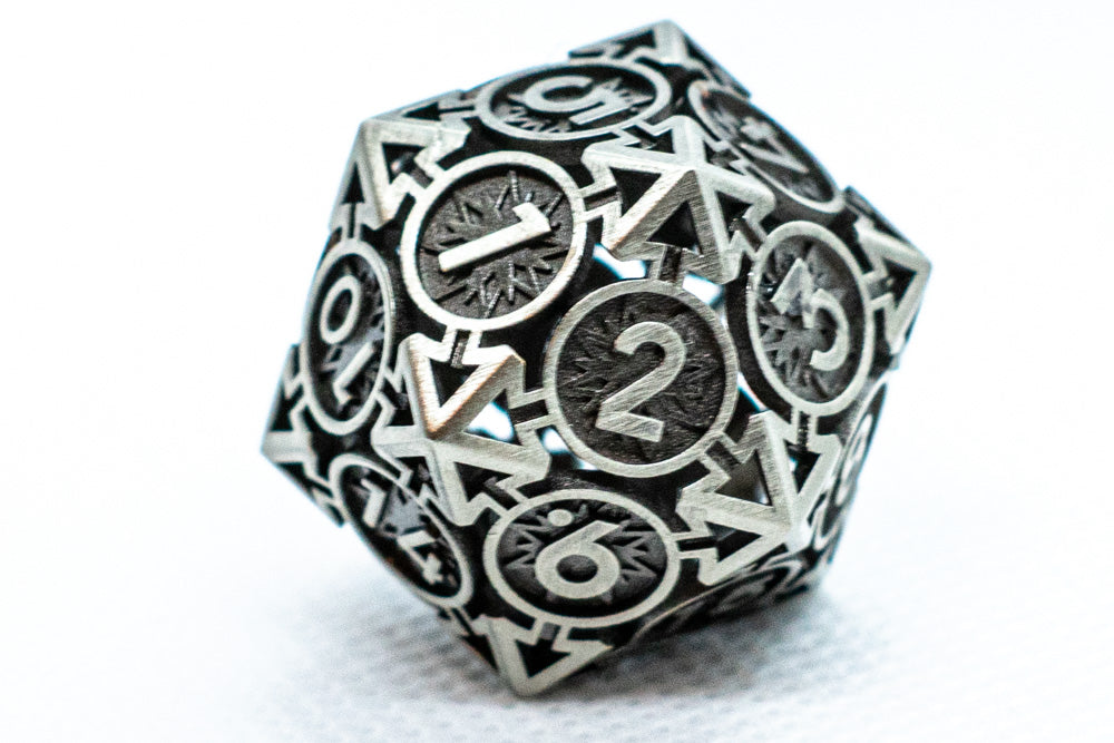 Metallic polyhedral dice with numbers on a white background