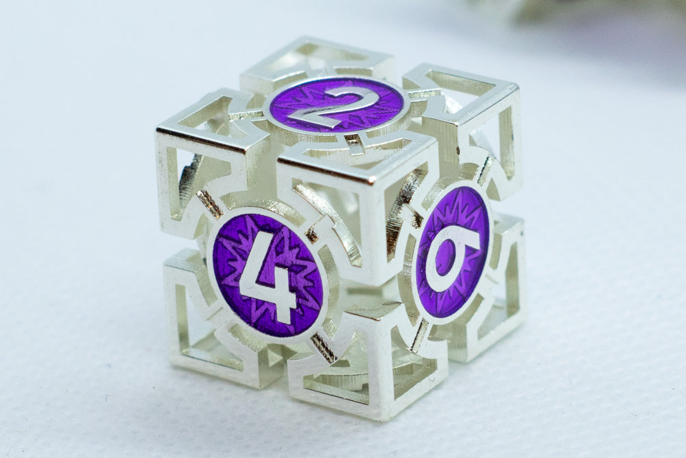 Silver die with purple numbers on a white background