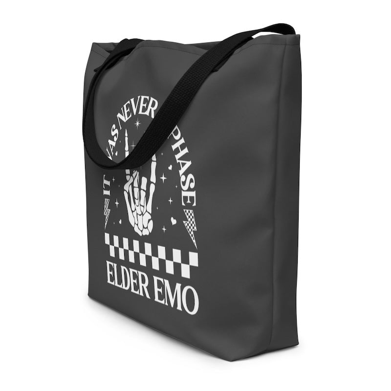 Black tote bag with white graphic design and text on a white background
