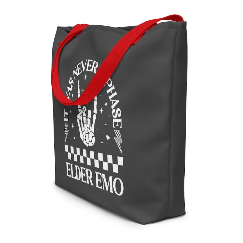 Black tote bag with red handles and white text on a white background