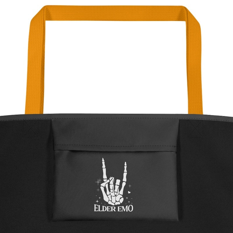 Black tote bag with 'Elder Emo' design and orange handles on a white background