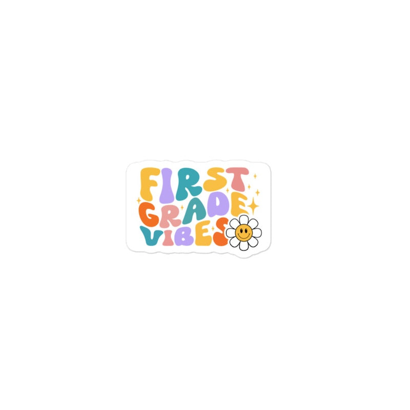 Sticker with 'First Grade Vibes' text and a flower on a white background