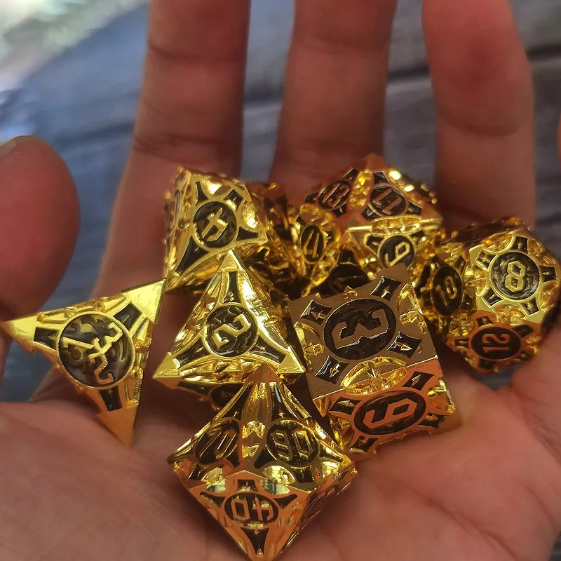 Gold polyhedral dice set held in a hand with a blurred background