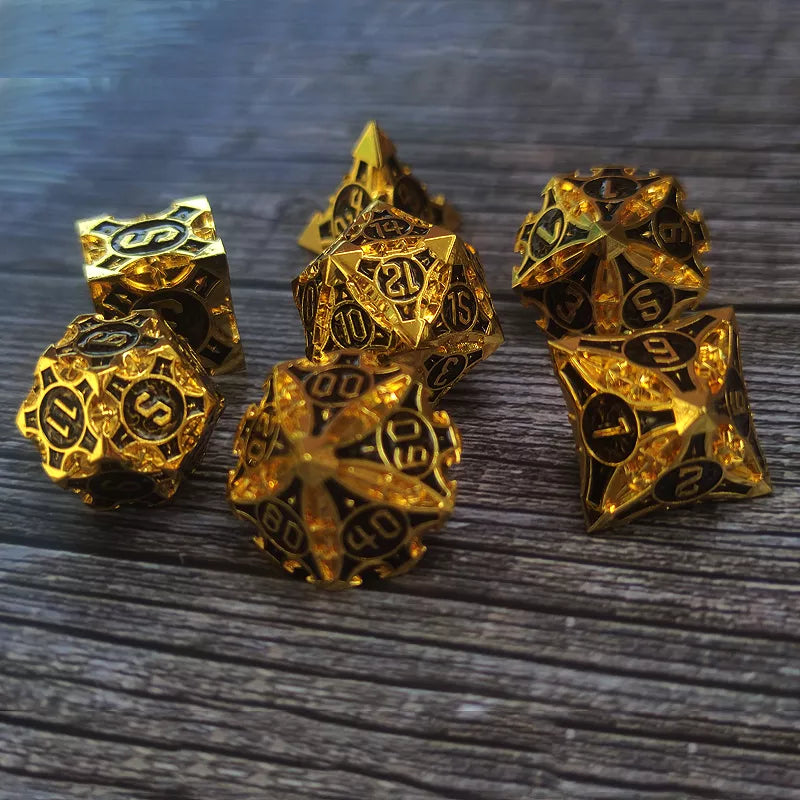 Set of gold polyhedral dice on a wooden surface