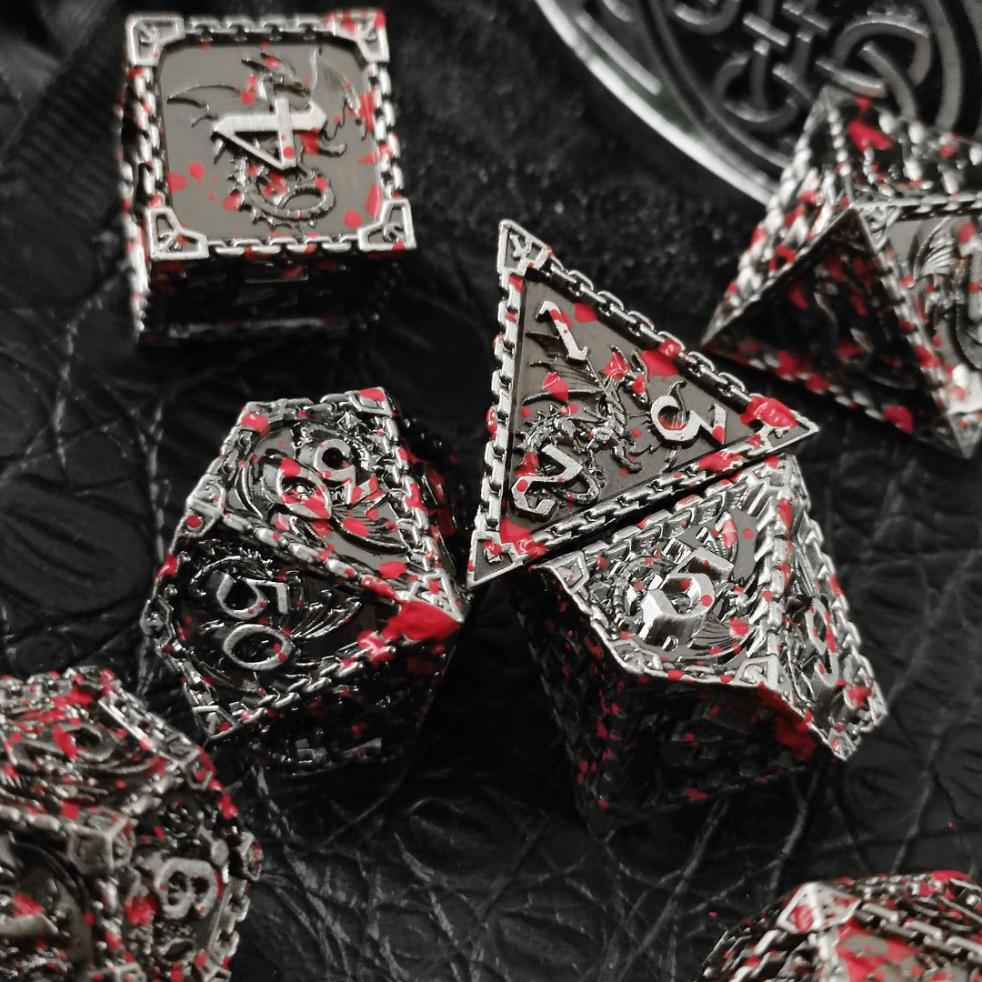 Close-up of polyhedral dice with red splatter design on a textured black background