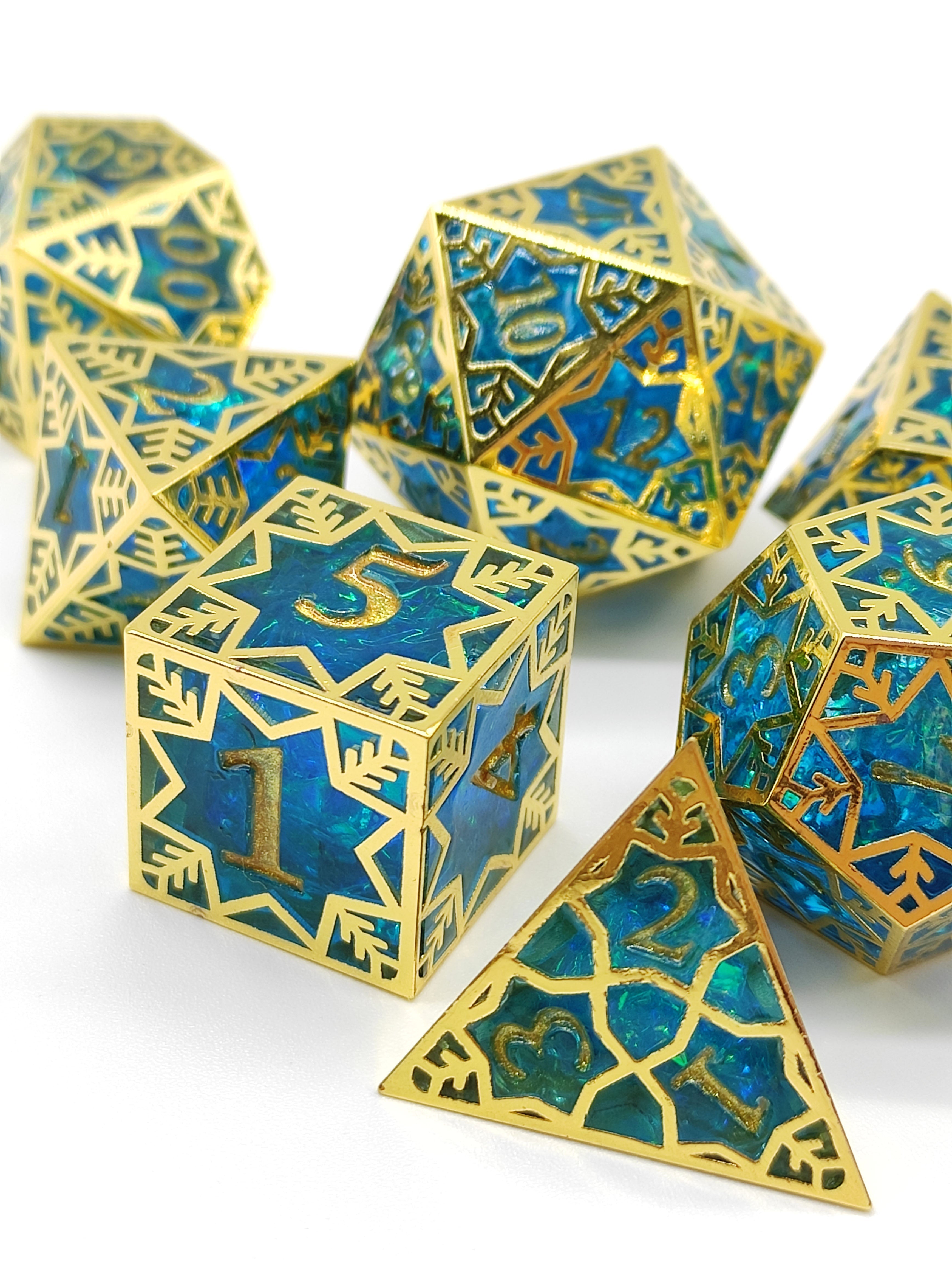 Set of blue and gold polyhedral dice on a white background