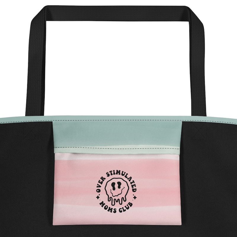 Tote bag with black handle, pink and green stripes, and 'Over Stimulated Moms Club' logo.