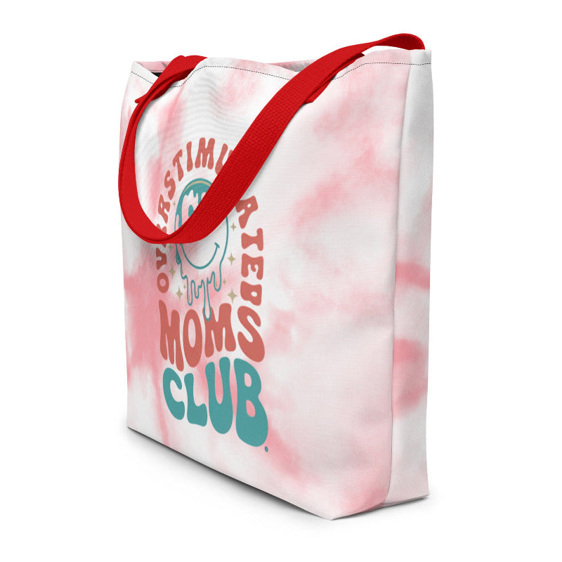 Tote bag with 'Moms Club' text and red handles on a white background