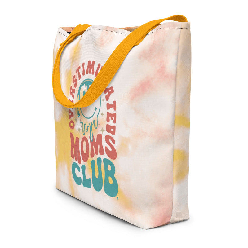 Tote bag with 'Moms Club' text and yellow handle on a white background