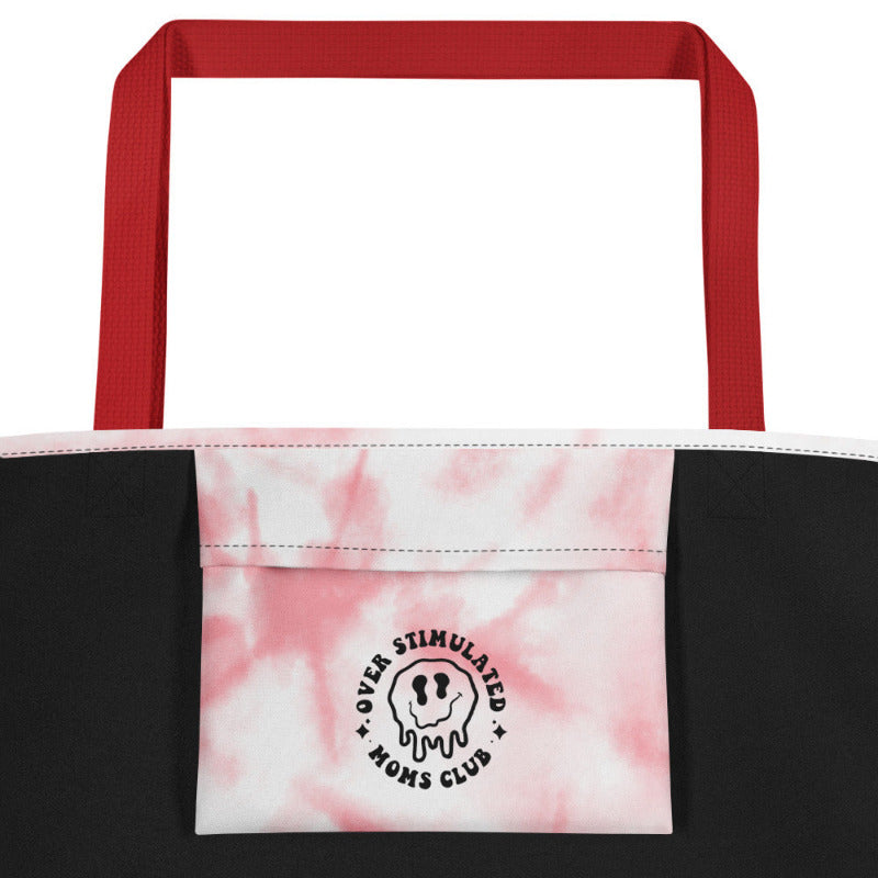 Tote bag with red handles and pink and black tie-dye pattern on a white background