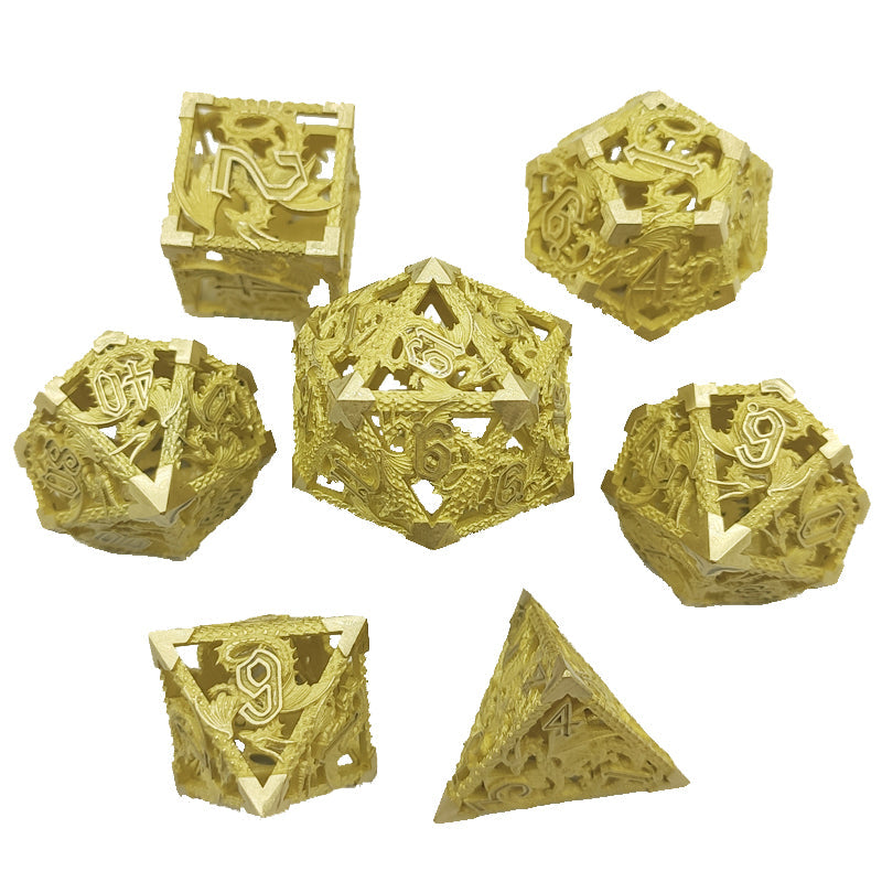 Set of gold metal dice with intricate designs on a white background